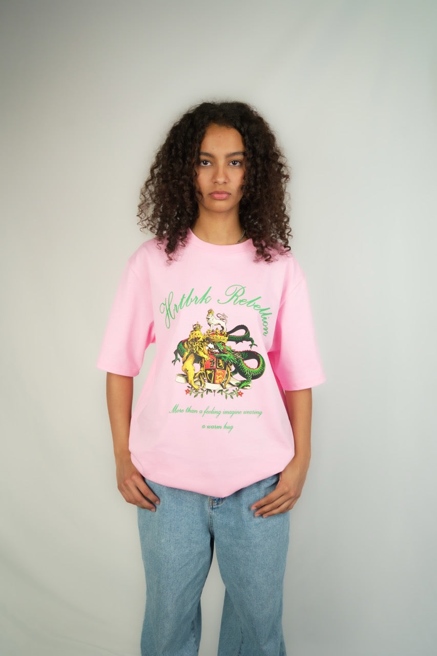 A girl wearing a pink shirt with green design that represents Calgary streetwear brand called HRTBRK