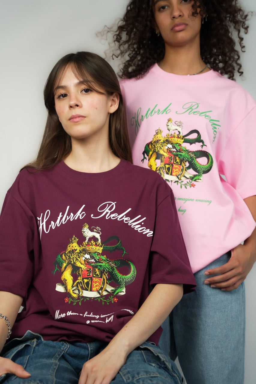 two people wearing a Calgary clothing brand called HRTBRK, the design contains a dragon with a lion. with the words "hrtbrk rebelion"